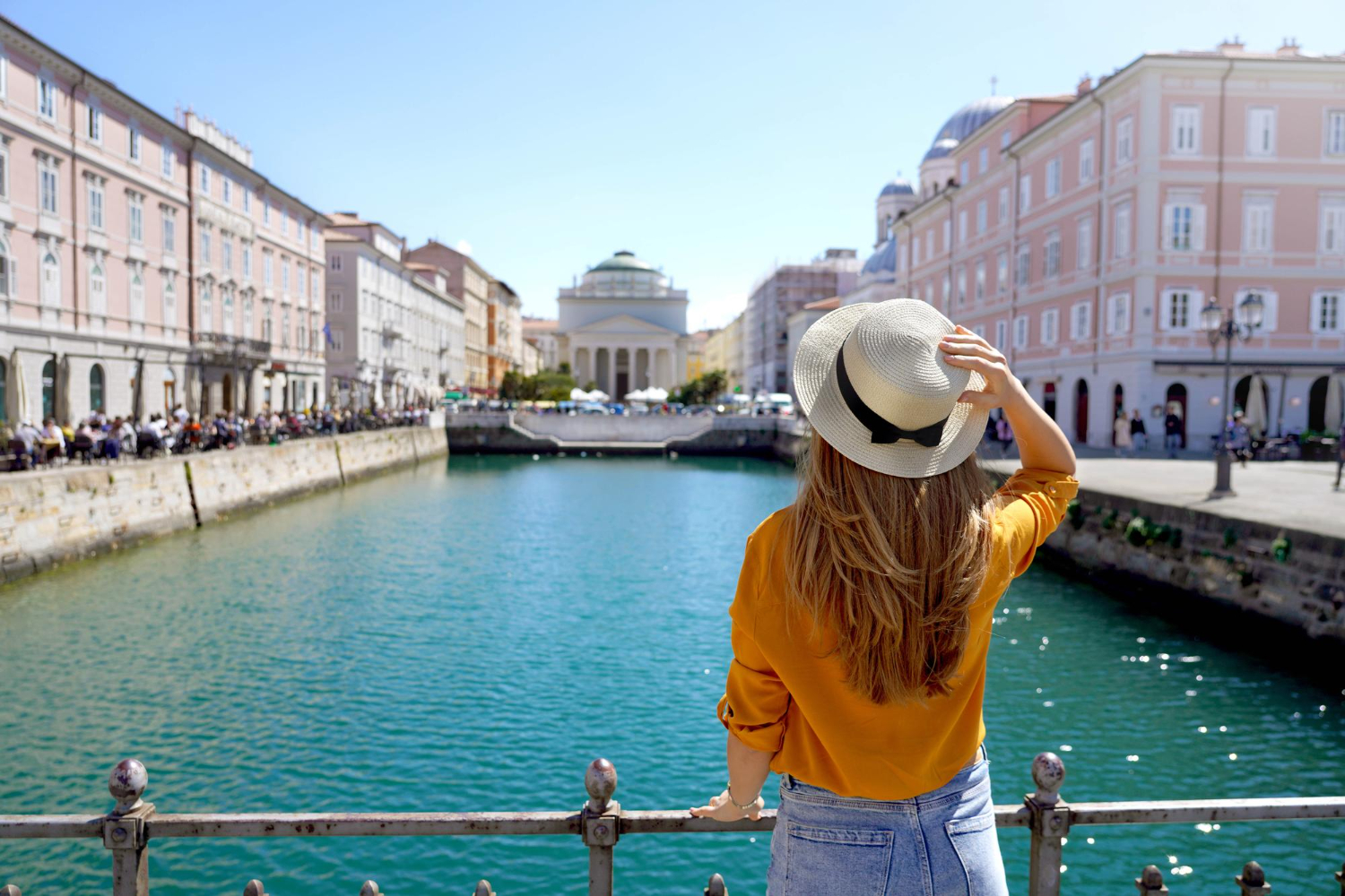 travel-trieste-italy-back-view-pretty-girl-holding-hat-looking-sant-antonio-taumaturgo-church-grand-canal-trieste-italy-beautiful-young-woman-visiting-europe